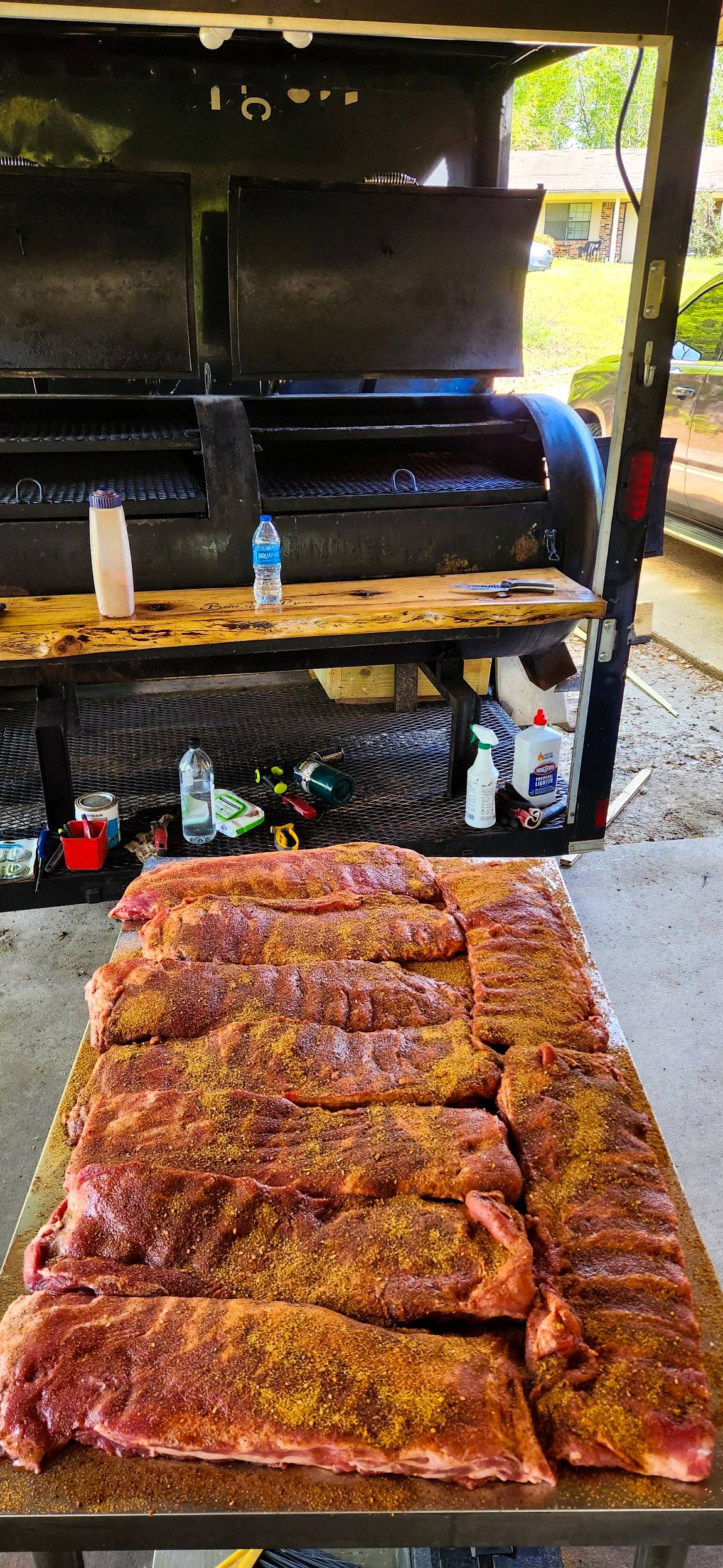 A full grate of ribs smoking on the offset